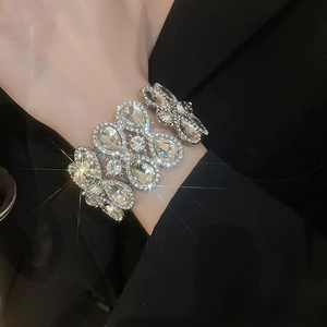 Close-up of a silver geometric diamond bracelet featuring pear and round cut rhinestones