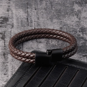 Detail of dark brown double-row braided leather bracelet with matte black magnetic clasp