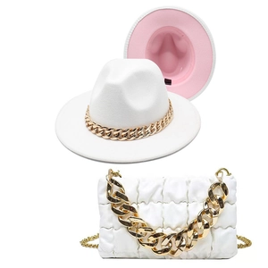 Close-up of a white wool jazz hat and quilted chain handbag with bold gold hardware
