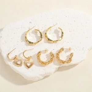 Three pairs of 14K gold plated earrings with heart pendants and textured C-shape hoops