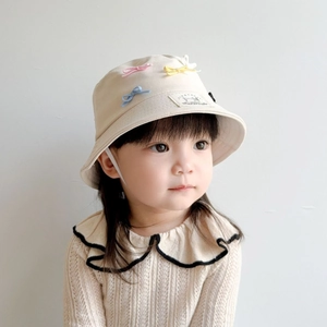 Children's beige sun hat with colorful bow decoration for outdoor sun protection