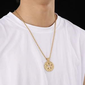 Hiphop gold star pendant necklace worn by model featuring circular runic details