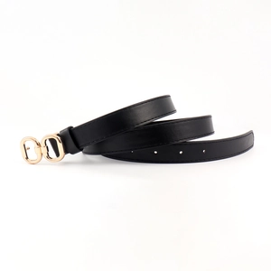 Detail of slim black leather belt with a polished gold double-ring buckle on white background