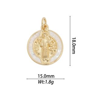 Macro detail of a round 18k gold plated Saint Benedict medal with white inlay 18x15mm
