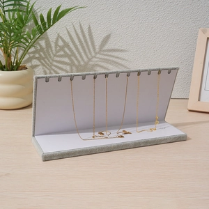 L-shaped light grey velvet jewelry display rack for necklaces with multiple slots