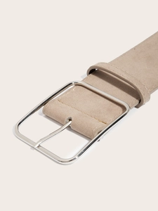 Close-up of beige suede waist belt featuring a polished silver metal buckle and fine stitching