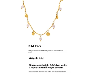 Detailed view of golden stainless steel necklace with freshwater pearls and shell charms