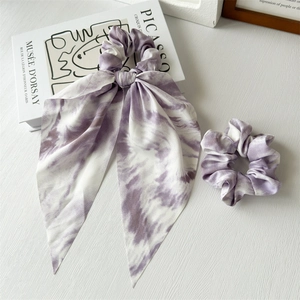 Elegant purple tie-dye chiffon scrunchie set with long streamer on art book background