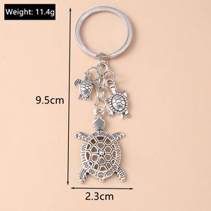 Detailed dimensions of silver turtle keychain featuring one large and two small turtles