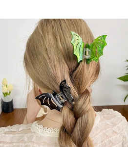 Gothic bat wing hair claw clips in neon green and black shown in a hairstyle