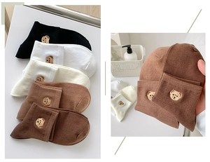 Detailed view of assorted cotton ankle socks featuring cute bear embroidery in neutral colors