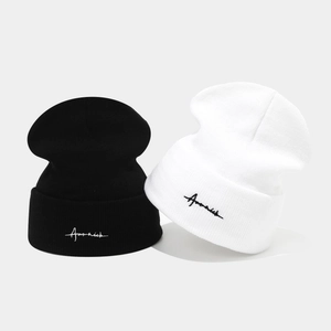Set of two black and white knitted beanies with cursive logo embroidery and ribbed texture