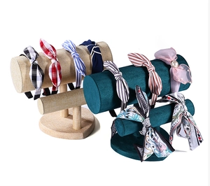 Close-up of bow headbands with pearl accents on linen and velvet display stands