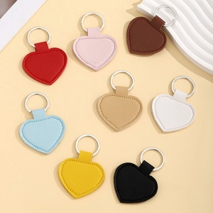 Multiple colorful heart-shaped PU leather keychains with neat stitching and silver rings