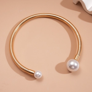 Detail shot of golden snake chain collar featuring large elegant white pearls