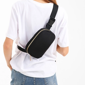 Waterproof nylon crossbody bag in black with golden zippers for outdoor sports