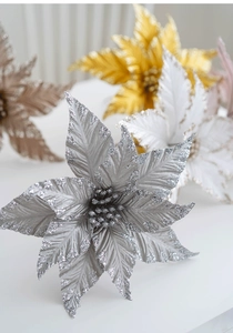 Close-up of artificial poinsettia with glitter petals for Christmas tree decoration