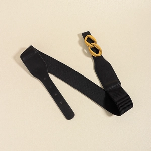 Elastic black waist belt with gold chain buckle and leather accents for dresses