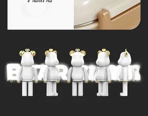 Detailed views of bear-shaped collectible figure in white with gold accents and metallic trim