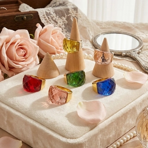 18k gold plated rings with colorful faceted crystals on white velvet display stand