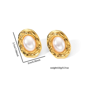Macro view of gold hammered oval earrings with white pearl inlay and size dimensions
