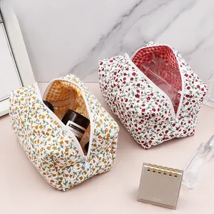Detail of floral makeup bag set with metal zipper and soft checkered inner lining