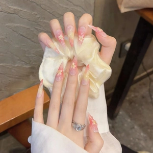 Handmade stiletto press-on nails with pink gradient and 3D floral cherry blossom art