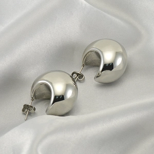 Minimalist silver stainless steel water drop earrings on soft white silk background