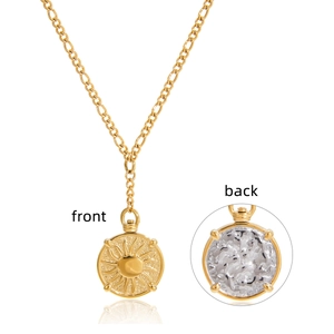 Detail of gold sun pendant necklace showing both front relief and white marble textured back