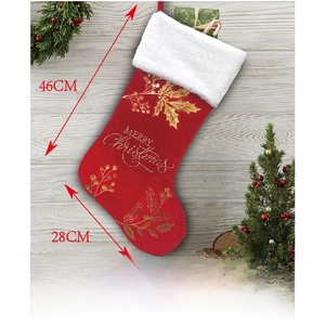 Detail of red velvet Christmas stocking with white trim and gold Merry Christmas print