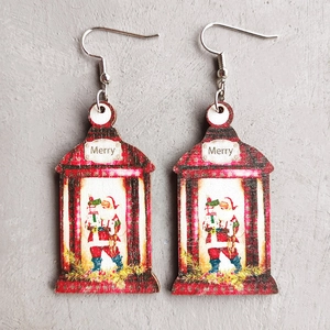 Detail of Christmas lantern and Santa Claus wooden earrings with Merry text print
