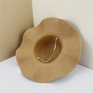 Detail of summer straw sun hat featuring wavy brim and white elastic windproof chin strap