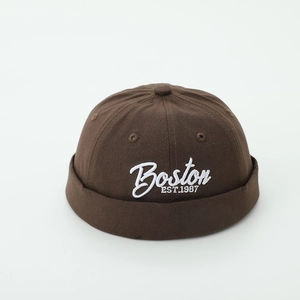 Close-up of 3D embroidery and breathable vent on a brown cotton brimless docker cap