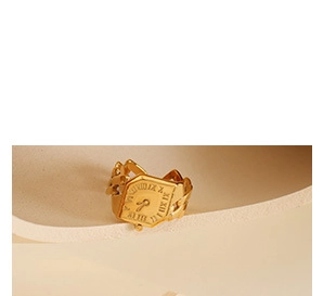 Detailed macro of gold watch-face ring with Roman numerals and Cuban link chain band