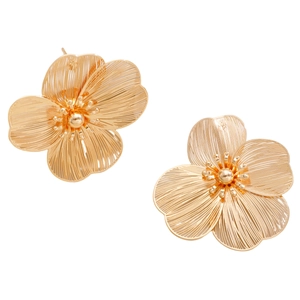 Macro view of gold flower earrings featuring intricate wire woven petal craftsmanship