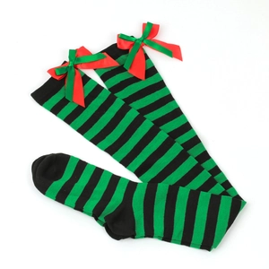 Detail of black and green striped over-knee socks with red festive ribbon bows