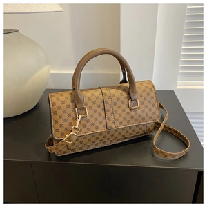 Detailed view of brown lychee texture leather handbag with vintage circular patterns