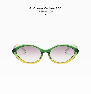 Detail of cat eye sunglasses with green to yellow gradient frame and purple lenses