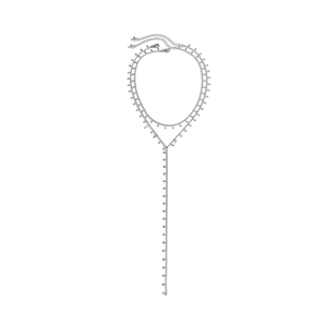 Macro detail of layered silver Y-necklace featuring metallic drop charms and long tassels