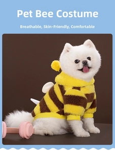 Detail of a bee-themed dog knit sweater with yellow stripes and small white wings