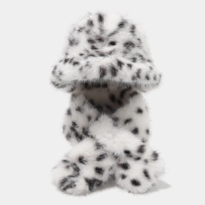 Detailed close-up of fluffy black and white spotted faux fur winter hat and scarf set
