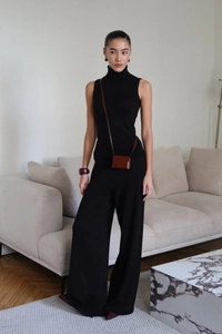 Minimalist black knitted sleeveless turtleneck top and wide-leg pants set detail