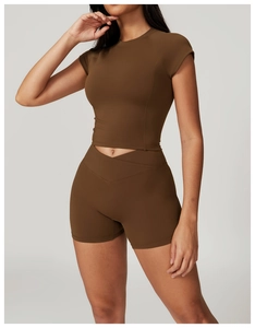 Detail of high-waist crisscross shorts and cropped yoga top in dark chocolate brown