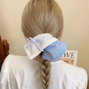 Blue plaid and lace bow scrunchie with pearl detail on braided ponytail hairstyle