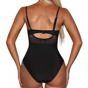 Detail of black one-piece swimsuit featuring mesh patchwork and backless cutout design