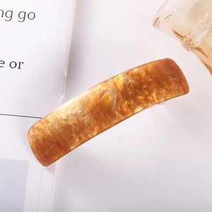 Detail of a brown marble acetate spring hair clip with unique tortoiseshell texture