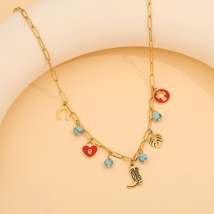 Detailed view of gold chain necklace featuring western boot, heart lock, and horseshoe charms