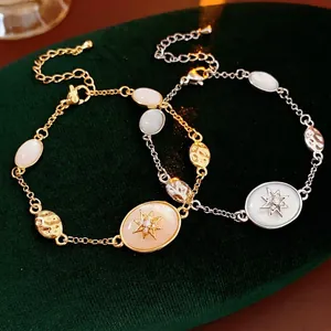 Elegant gold and silver oval star bracelets with zircon inlay on green velvet surface