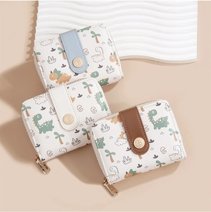 Detailed view of three white compact wallets with cute cartoon dinosaur prints and color straps