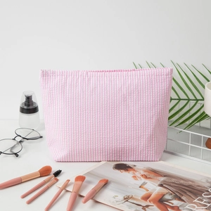 Pink striped seersucker makeup bag with a soft texture for travel storage